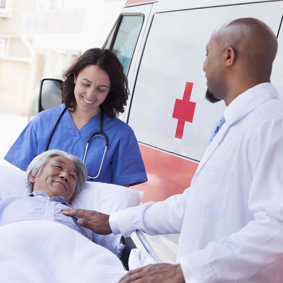 man on a stretcher coming out of an ambulance